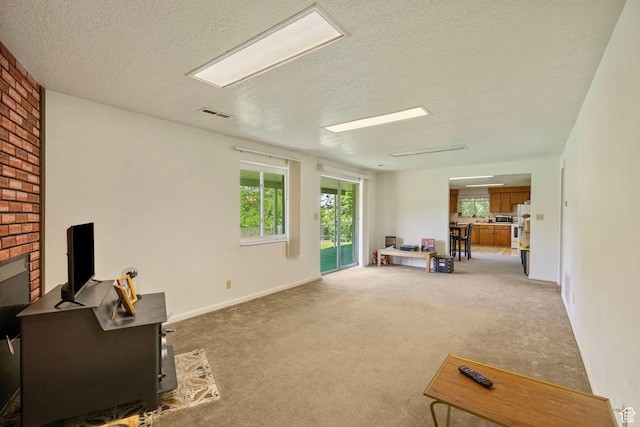 2718 E 200 N, Layton, UT 84040 - living room with light colored carpet, a textured ceiling, and baseboards