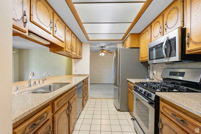 2718 E 200 N, Layton, UT 84040 - kitchen featuring appliances with stainless steel finishes, a sink, brown cabinetry, light tile patterned flooring, and a ceiling fan
