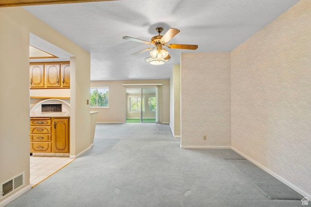 2718 E 200 N, Layton, UT 84040 - unfurnished living room with carpet flooring, a ceiling fan, a textured ceiling, and baseboards