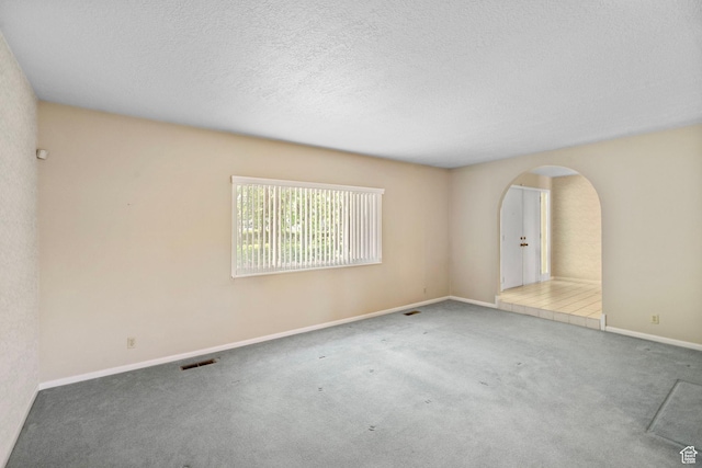 2718 E 200 N, Layton, UT 84040 - carpeted empty room featuring arched walkways, baseboards, and a textured ceiling