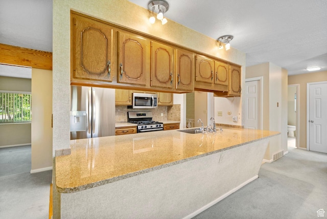 2718 E 200 N, Layton, UT 84040 - kitchen featuring appliances with stainless steel finishes, a sink, light carpet, and baseboards