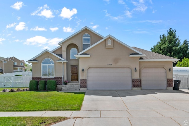14008 S Emmeline Dr, Herriman, UT 84096 - view of front of property featuring brick siding, concrete driveway, a garage, and stucco siding