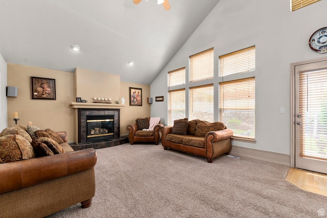 14008 S Emmeline Dr, Herriman, UT 84096 - carpeted living room with healthy amount of natural light, a tiled fireplace, ceiling fan, baseboards, and high vaulted ceiling