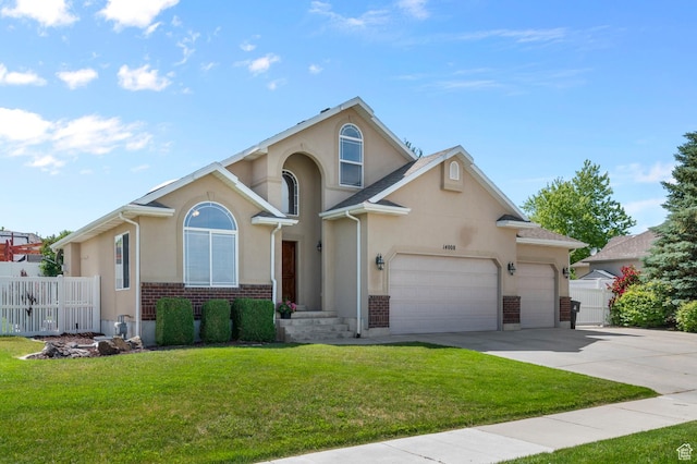 14008 S Emmeline Dr, Herriman, UT 84096 - view of front of house featuring driveway, stucco siding, a garage, and brick siding