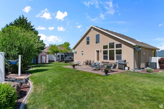 14008 S Emmeline Dr, Herriman, UT 84096 - back of property with stucco siding, a patio area, central air condition unit, and a yard