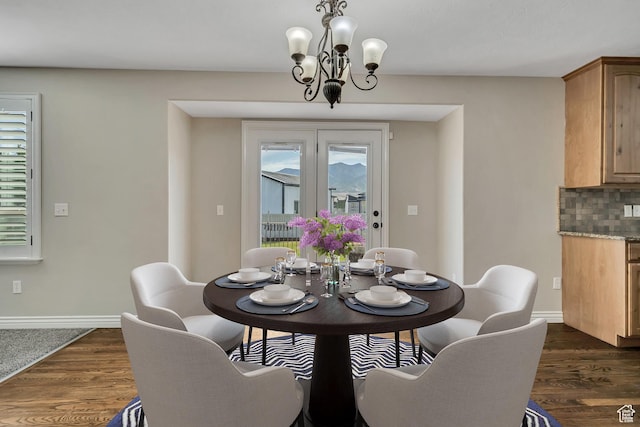 5258 N Ponderosa Ln, Stansbury Park, UT 84074 - dining space with a chandelier, dark wood finished floors, and baseboards