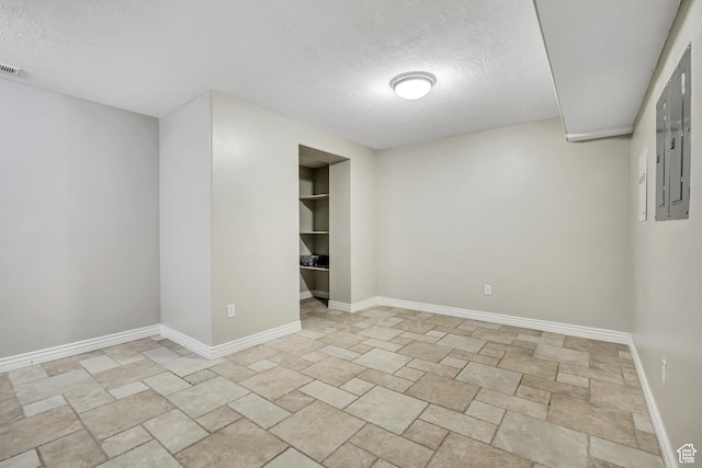 5258 N Ponderosa Ln, Stansbury Park, UT 84074 - spare room featuring a textured ceiling, light stone finish flooring, and baseboards