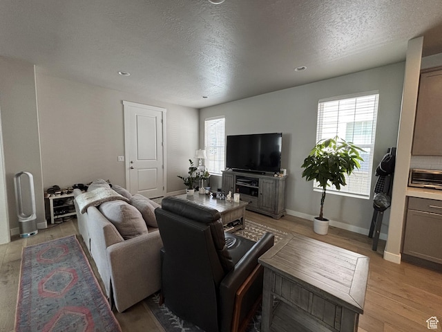 11603 S Outfitter Way S, Jordan, UT 84009 - living area with a textured ceiling, plenty of natural light, light wood-type flooring, baseboards, and recessed lighting