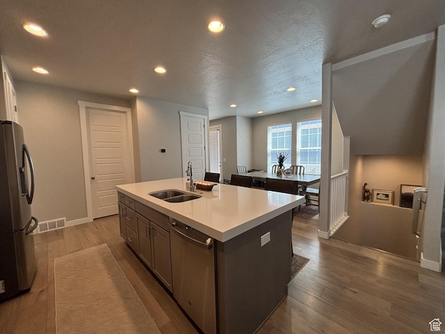 11603 S Outfitter Way S, Jordan, UT 84009 - kitchen featuring a sink, stainless steel appliances, hardwood / wood-style floors, recessed lighting, and an island with sink