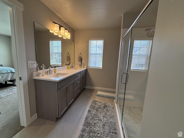 11603 S Outfitter Way S, Jordan, UT 84009 - full bathroom with ensuite bathroom, a stall shower, double vanity, baseboards, and a textured ceiling