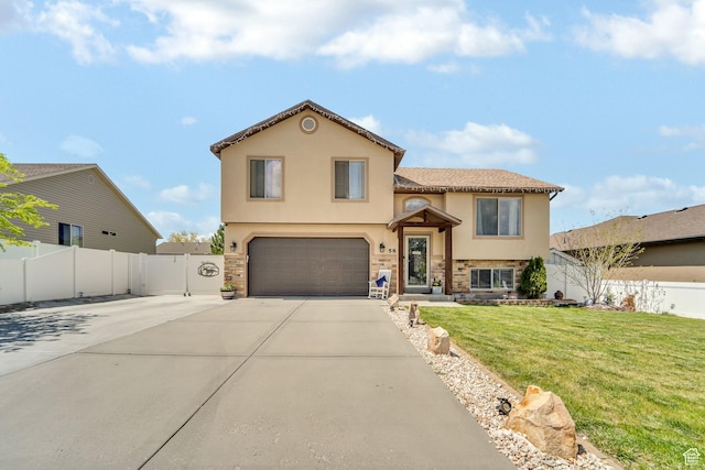 583 N 640 W, Tooele, UT 84074 - view of front of house featuring stone siding, a garage, stucco siding, and concrete driveway