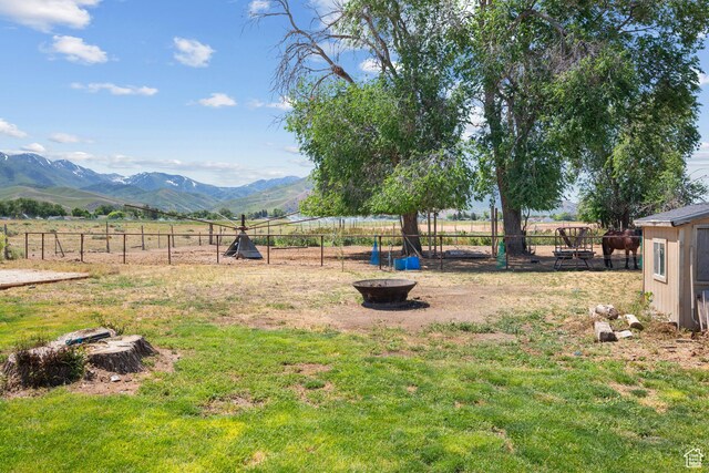 745 W Mckellar, Tooele, UT 84074 - view of yard with a mountain view, an outdoor fire pit, and a rural view