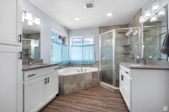 745 W Mckellar, Tooele, UT 84074 - full bathroom featuring two vanities, a shower stall, a bath, wood finished floors, and recessed lighting
