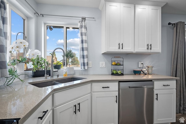 745 W Mckellar, Tooele, UT 84074 - kitchen featuring dishwasher, a sink, white cabinets, and light stone countertops