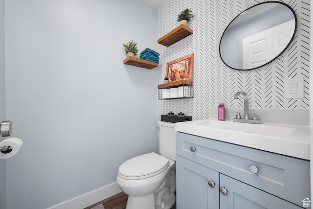 745 W Mckellar, Tooele, UT 84074 - half bathroom with toilet, vanity, baseboards, and wood finished floors