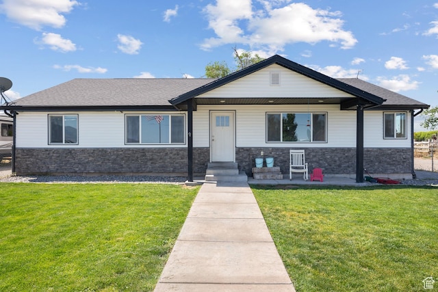 745 W Mckellar, Tooele, UT 84074 - view of front facade featuring stone siding, a front lawn, and roof with shingles