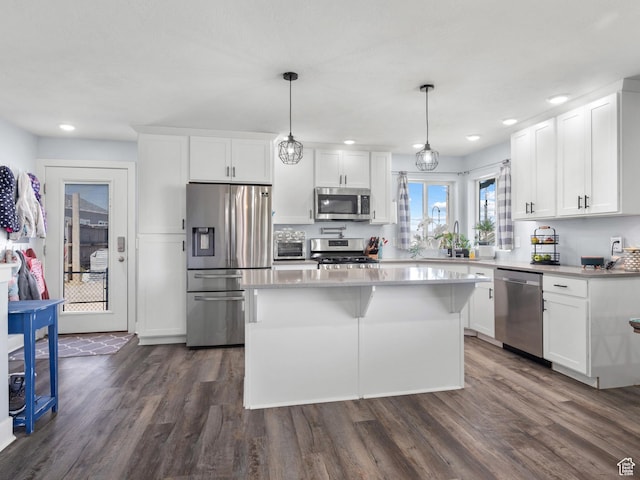 745 W Mckellar, Tooele, UT 84074 - kitchen with stainless steel appliances, dark wood-style floors, a kitchen island, white cabinetry, and recessed lighting
