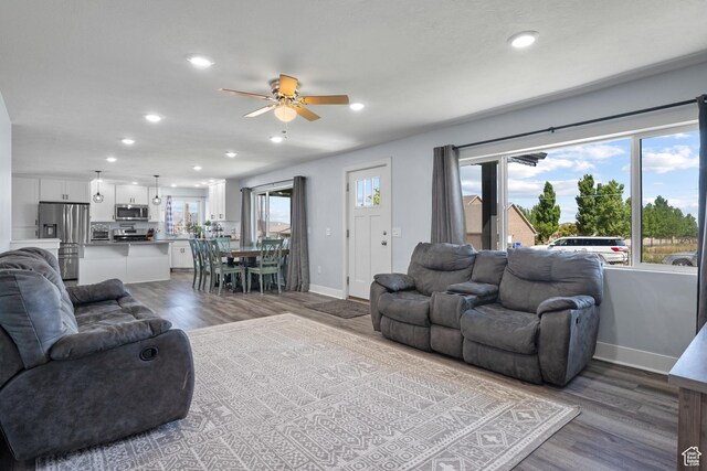 745 W Mckellar, Tooele, UT 84074 - living room with a ceiling fan, wood finished floors, baseboards, and recessed lighting