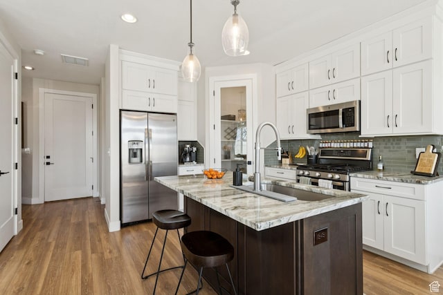 3779 S 3250 W, West Haven, UT 84401 - kitchen with stainless steel appliances, decorative backsplash, white cabinets, and recessed lighting
