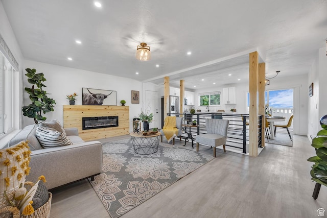 5494 W Townsend Way, West Valley City, UT 84118 - living room with recessed lighting, light wood-style floors, and a glass covered fireplace
