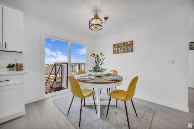 5494 W Townsend Way, West Valley City, UT 84118 - dining space with light wood-style floors, a chandelier, and baseboards