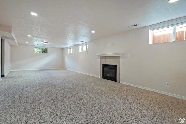 628 E Wyandotte Ave S, Sandy, UT 84070 - below grade area featuring recessed lighting, carpet flooring, a tiled fireplace, and baseboards