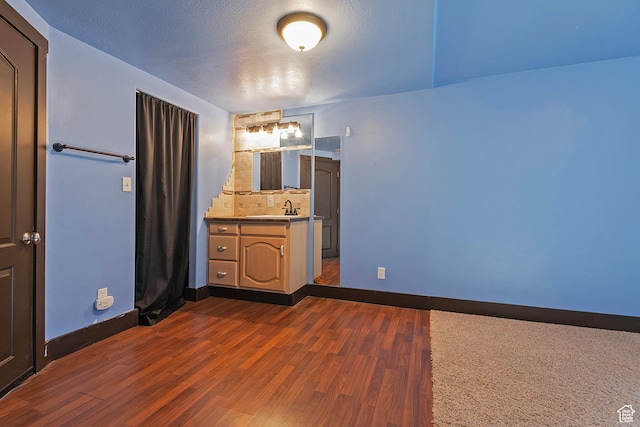 628 E Wyandotte Ave S, Sandy, UT 84070 - bathroom featuring wood finished floors, baseboards, vanity, and tasteful backsplash