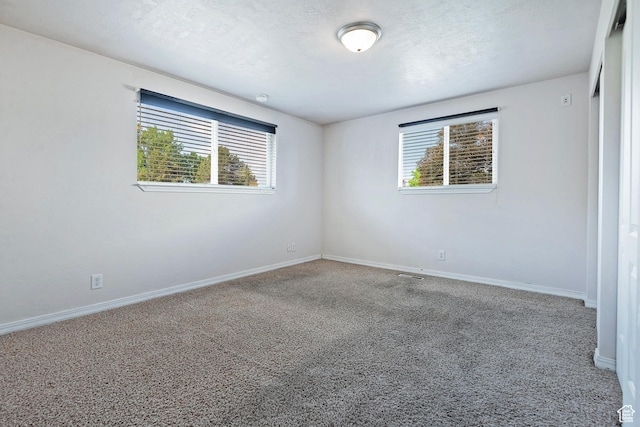 628 E Wyandotte Ave S, Sandy, UT 84070 - carpeted empty room featuring baseboards and a textured ceiling