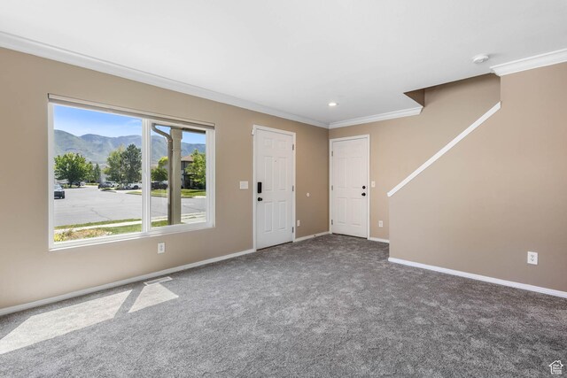 410 Wheatridge Rd, Stansbury Park, UT 84074 - carpeted entryway featuring ornamental molding, a mountain view, baseboards, and recessed lighting