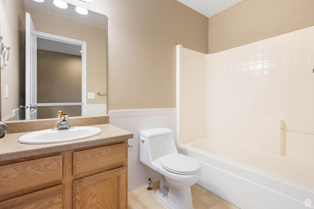 410 Wheatridge Rd, Stansbury Park, UT 84074 - full bathroom with a wainscoted wall, toilet, vanity, tile patterned floors, and bathing tub / shower combination