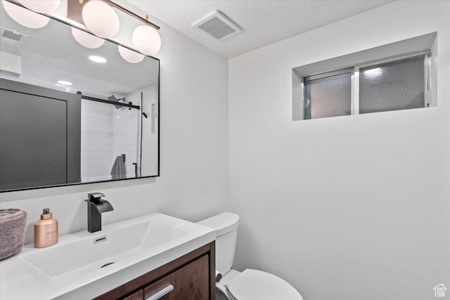 1392 N 450 E, Bountiful, UT 84010 - bathroom featuring vanity, toilet, a tile shower, a textured ceiling, and recessed lighting