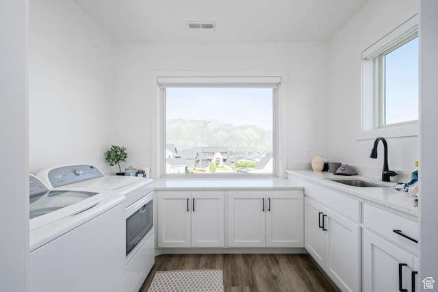 12184 N Bridgegate Way, Highland, UT 84003 - washroom featuring washer and clothes dryer, cabinet space, dark wood-style floors, and a mountain view