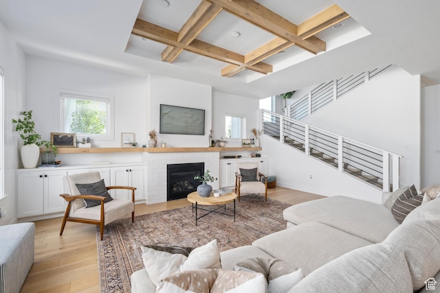 12184 N Bridgegate Way, Highland, UT 84003 - living room with coffered ceiling, light wood-style floors, beamed ceiling, stairs, and a brick fireplace