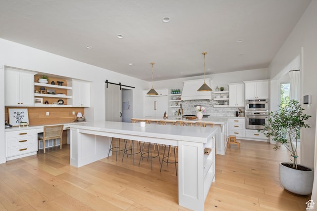12184 N Bridgegate Way, Highland, UT 84003 - kitchen featuring open shelves, a barn door, stainless steel double oven, backsplash, and light countertops