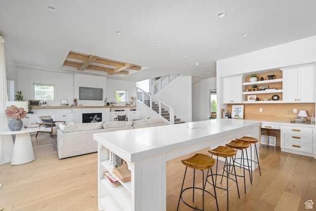 12184 N Bridgegate Way, Highland, UT 84003 - kitchen featuring open shelves, coffered ceiling, a center island, recessed lighting, and light wood-style flooring