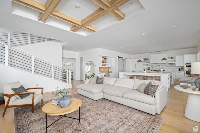 12184 N Bridgegate Way, Highland, UT 84003 - living area with a barn door, coffered ceiling, light wood-style floors, beam ceiling, and stairway