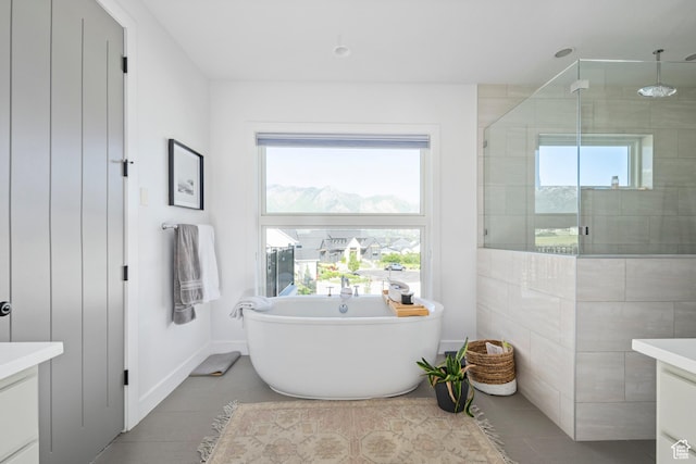 12184 N Bridgegate Way, Highland, UT 84003 - bathroom featuring vanity, a tile shower, a soaking tub, tile patterned floors, and baseboards