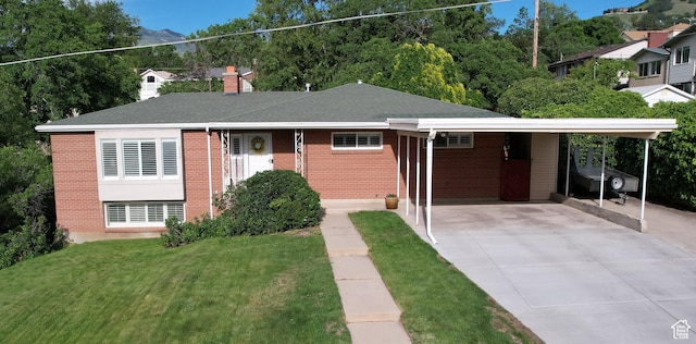 3243 S 200 W, Bountiful, UT 84010 - view of front of house with brick siding, concrete driveway, a front yard, and an attached carport