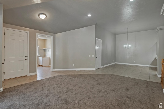3423 W Mount Cortina Way, Riverton, UT 84065 - carpeted empty room with tile patterned floors, a chandelier, and baseboards