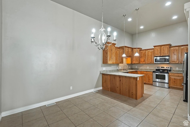 3423 W Mount Cortina Way, Riverton, UT 84065 - kitchen with appliances with stainless steel finishes, a peninsula, baseboards, a sink, and a chandelier