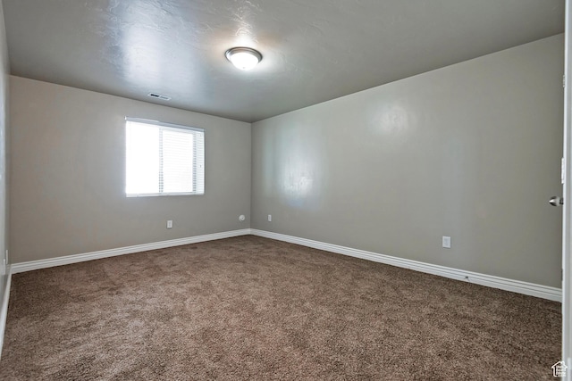 3423 W Mount Cortina Way, Riverton, UT 84065 - empty room featuring dark colored carpet and baseboards