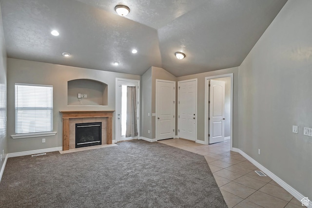 3423 W Mount Cortina Way, Riverton, UT 84065 - unfurnished living room with light tile patterned floors, a fireplace, vaulted ceiling, baseboards, and recessed lighting