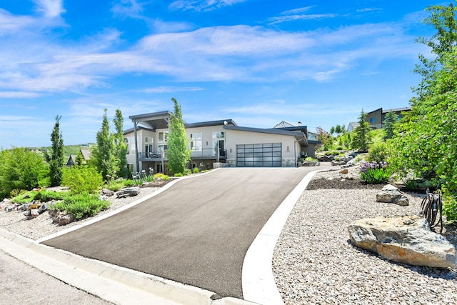 6339 E Quail Ln, Huntsville, UT 84317 - contemporary house with stone siding, asphalt driveway, and a garage