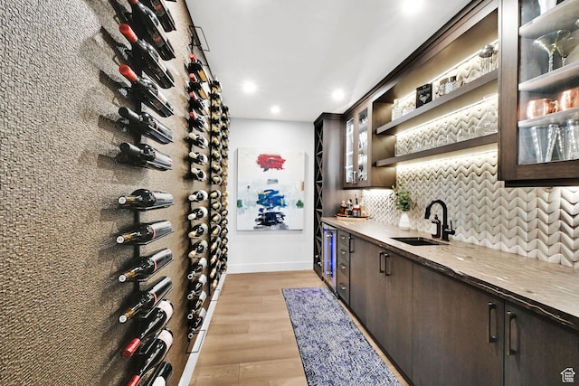 6339 E Quail Ln, Huntsville, UT 84317 - wine room with wet bar, light wood finished floors, recessed lighting, baseboards, and beverage cooler