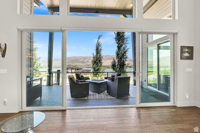 6339 E Quail Ln, Huntsville, UT 84317 - doorway with plenty of natural light, a mountain view, baseboards, and wood finished floors