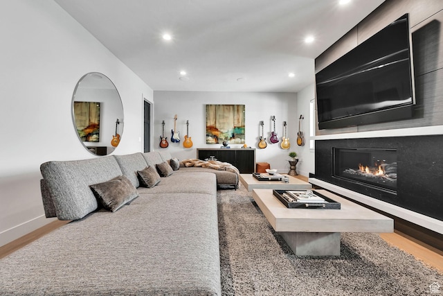 6339 E Quail Ln, Huntsville, UT 84317 - living area with recessed lighting, a glass covered fireplace, wood finished floors, and baseboards
