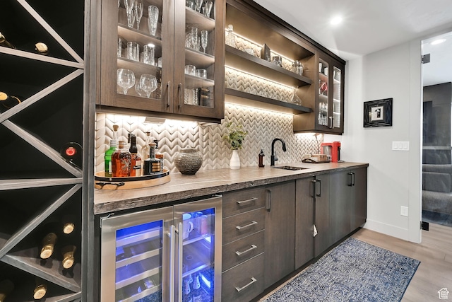 6339 E Quail Ln, Huntsville, UT 84317 - indoor wet bar with wine cooler, tasteful backsplash, light wood-style flooring, and baseboards