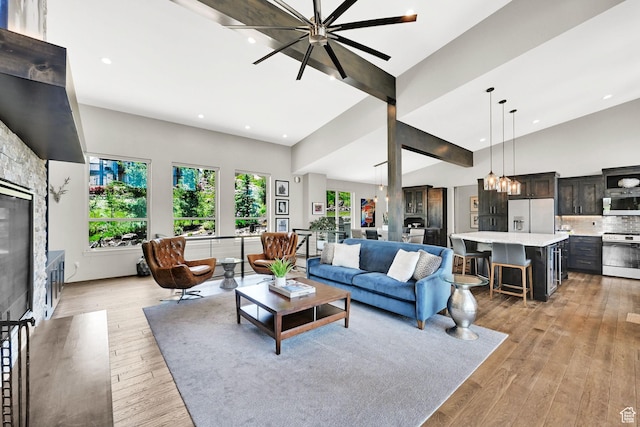 6339 E Quail Ln, Huntsville, UT 84317 - living area featuring recessed lighting, light wood-style flooring, high vaulted ceiling, a chandelier, and a glass covered fireplace