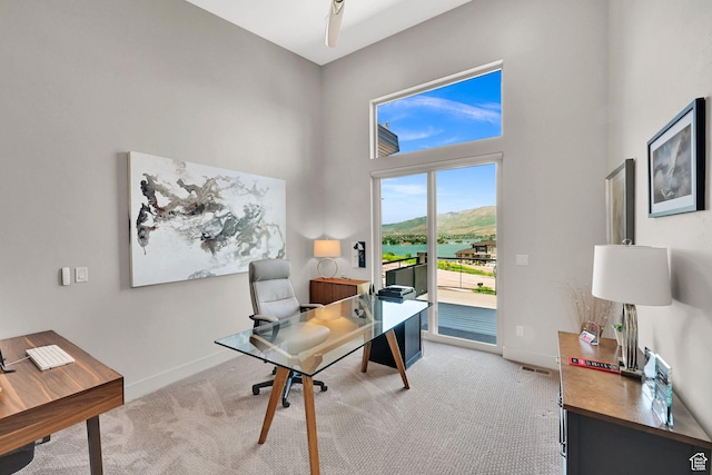 6339 E Quail Ln, Huntsville, UT 84317 - home office with light carpet, a high ceiling, baseboards, and a water view