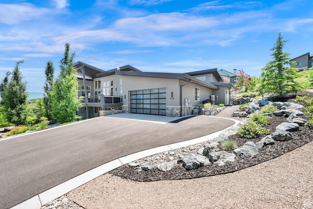 6339 E Quail Ln, Huntsville, UT 84317 - modern home with asphalt driveway, an attached garage, and stone siding
